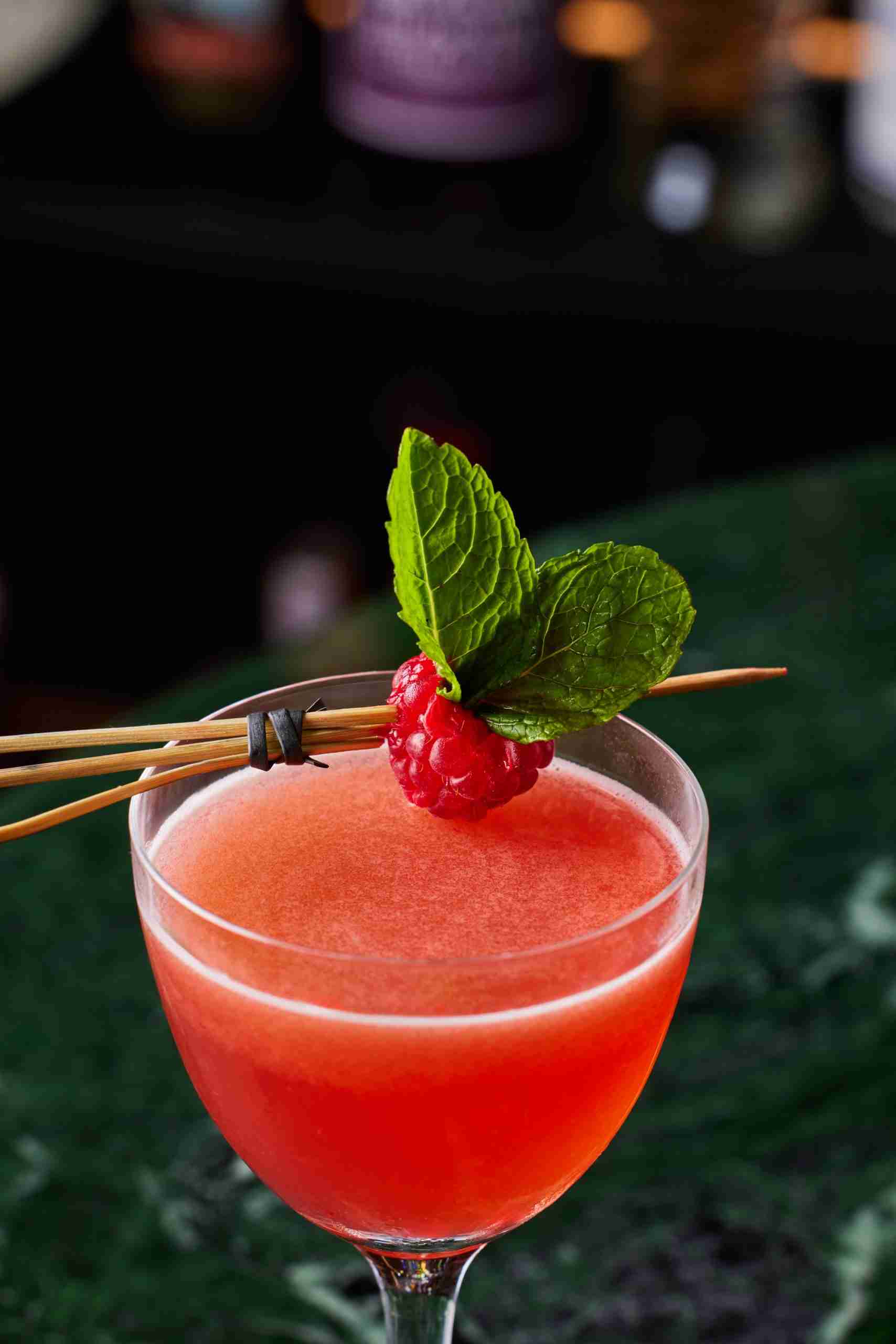Fruity cocktail with raspberry and mint garnish