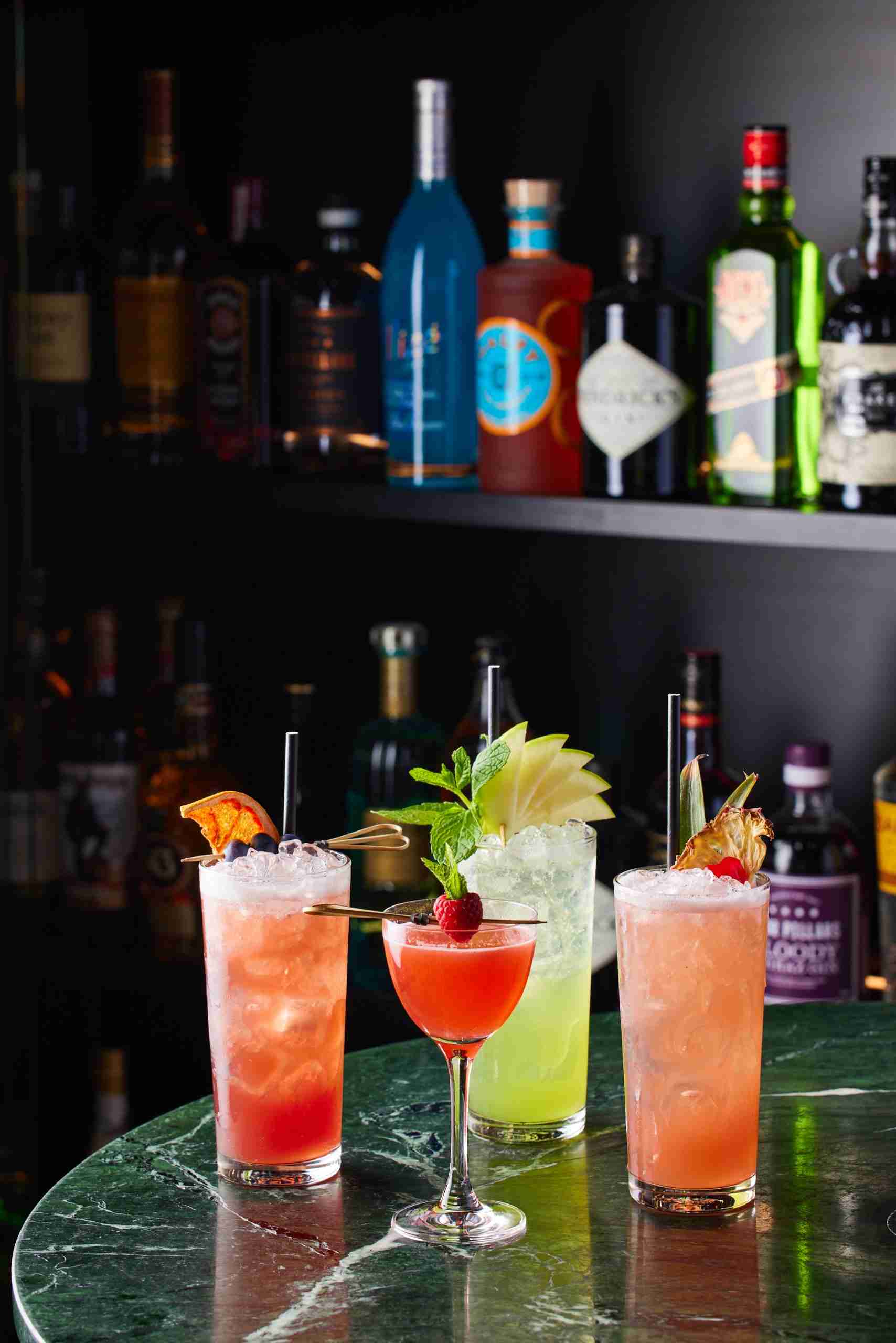 Colorful cocktails adorned with fresh fruit in restaurant