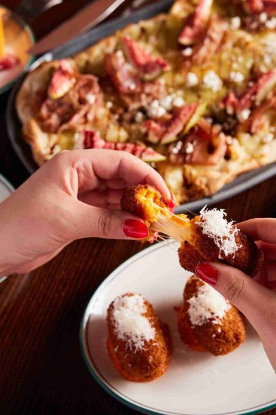 Arancini dish with cheese pull
