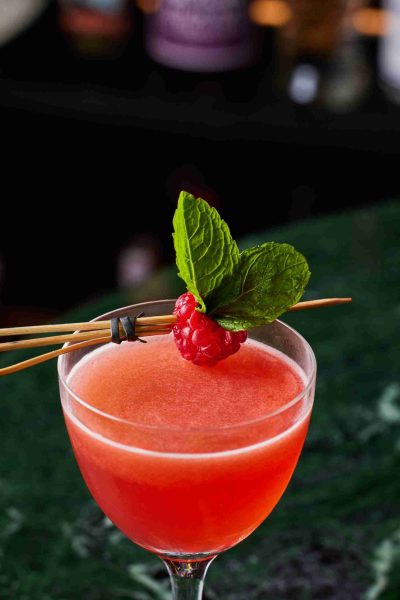 Fruity cocktail with raspberry and mint garnish